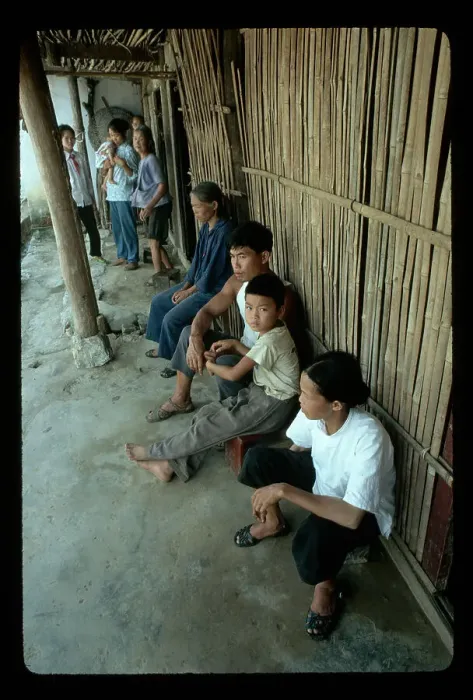 Framed Print : Family Seated Against Bamboo Wall Framed Print : Family Seated Against Bamboo Wall