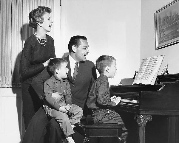 Family singing around piano