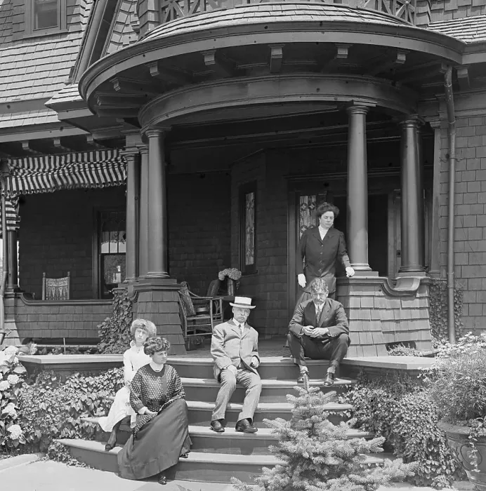 Framed Print : Family Sitting on Porch of Victorian Style House Framed Print : Family Sitting on Porch of Victorian Style House