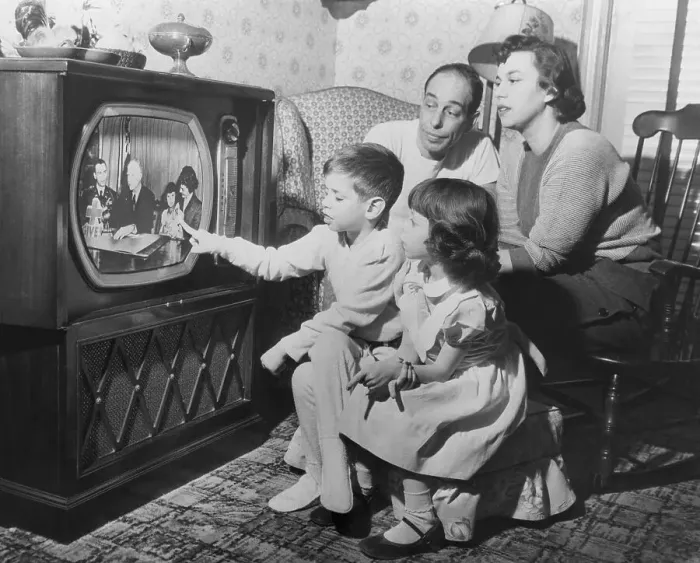 Framed Print : Family Watches Daughter on Television Framed Print : Family Watches Daughter on Television