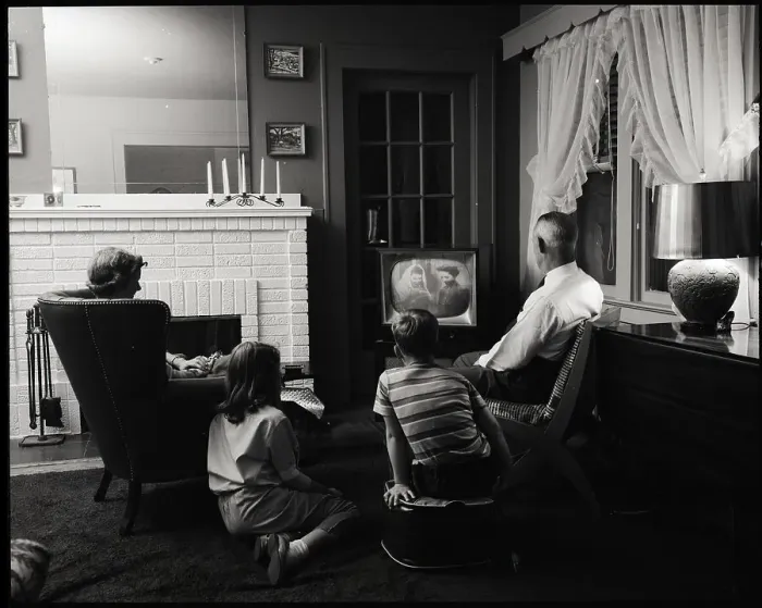 Framed Print : Family Watching Television in Living Room Framed Print : Family Watching Television in Living Room