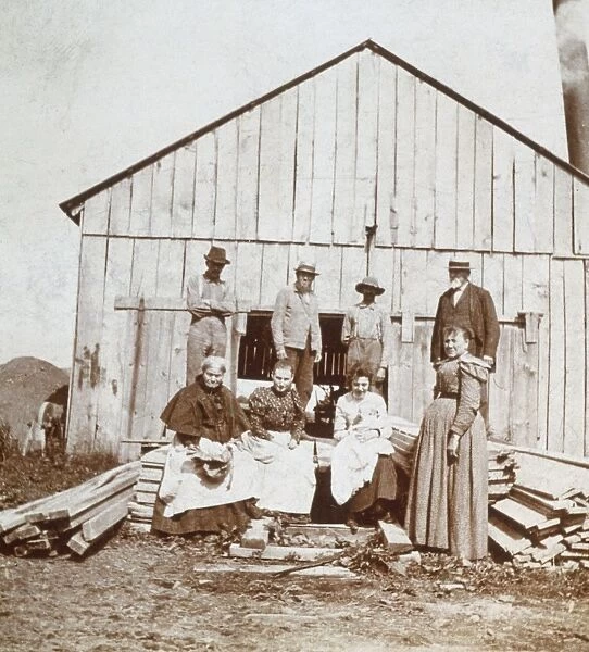 Farm Family. A farming family posing outside their house, circa 1895