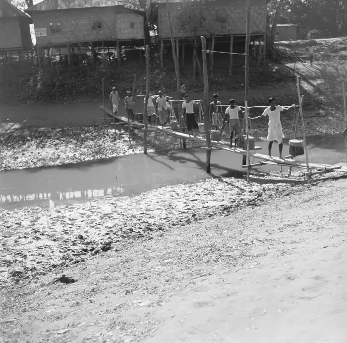 Framed Print : Farmer Crossing Makeshift Bridge over River Framed Print : Farmer Crossing Makeshift Bridge over River