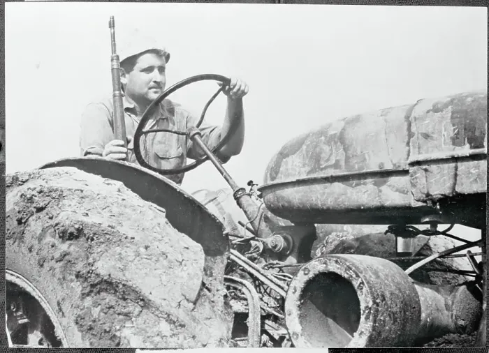 Framed Print : Farmer Driving Tractor with Rifle Framed Print : Farmer Driving Tractor with Rifle