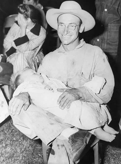 Framed Print : Farmer Holds His 18-Month-Old Son on Lap Framed Print : Farmer Holds His 18-Month-Old Son on Lap