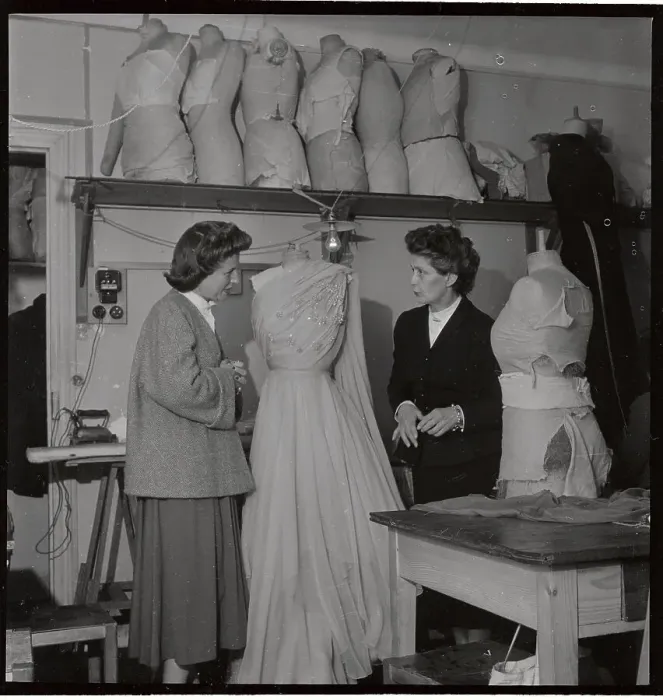 Framed Print : Fashion Designer and Assistant Discussing Dress Framed Print : Fashion Designer and Assistant Discussing Dress