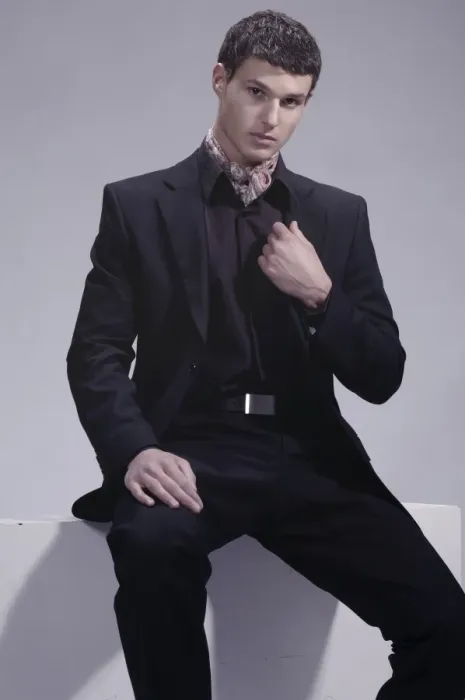 Framed Print : Fashion shot of a young man wearing a suit, sitting Framed Print : Fashion shot of a young man wearing a suit, sitting