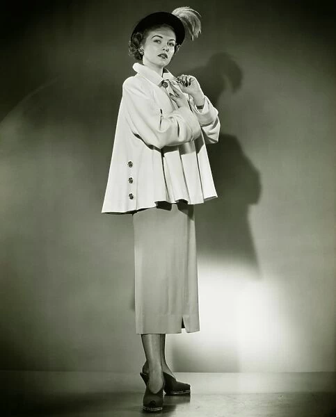 Fashionable woman posing in studio, (B&W), portrait