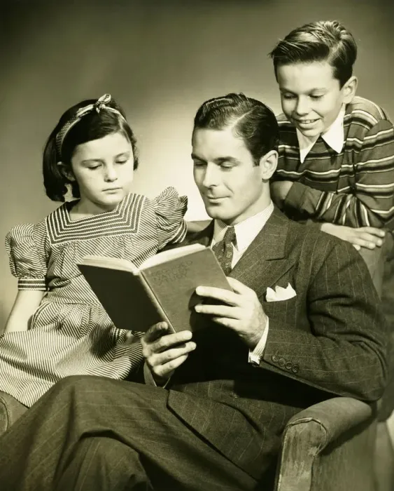 Framed Print : Father reading to son (4-5) and daughter ( 6-7) in studio, (B&W), portrait Framed Print : Father reading to son (4-5) and daughter ( 6-7) in studio, (B&W), portrait