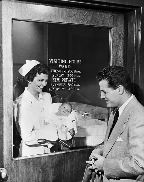 Framed Print : Father Viewing Baby Through Hospital Window Framed Print : Father Viewing Baby Through Hospital Window