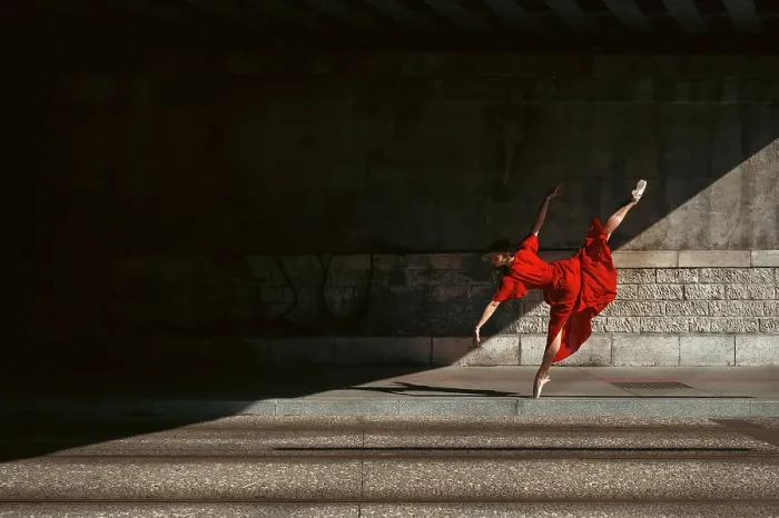 Framed Print : Female ballet dancer dancing with pointes in the street with a long red dress Framed Print : Female ballet dancer dancing with pointes in the street with a long red dress