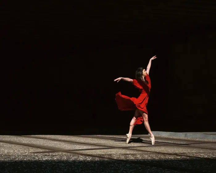 Framed Print : Female ballet dancer dancing with pointes in the street with a long red dress Framed Print : Female ballet dancer dancing with pointes in the street with a long red dress