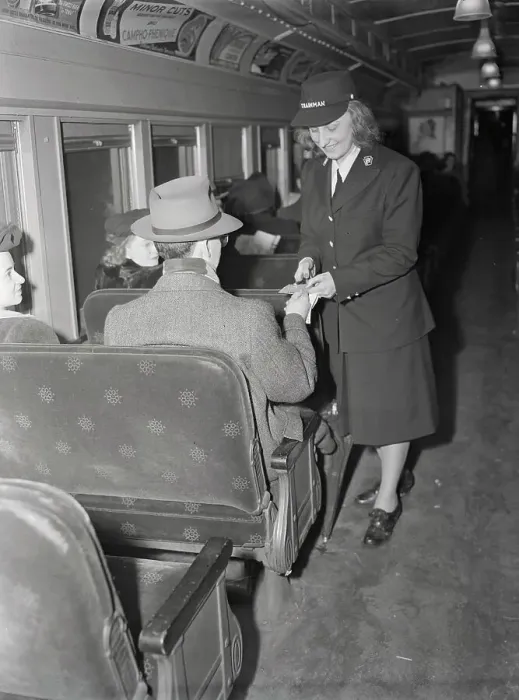 Framed Print : Female Conductor Taking Train Ticket from Passenger Framed Print : Female Conductor Taking Train Ticket from Passenger
