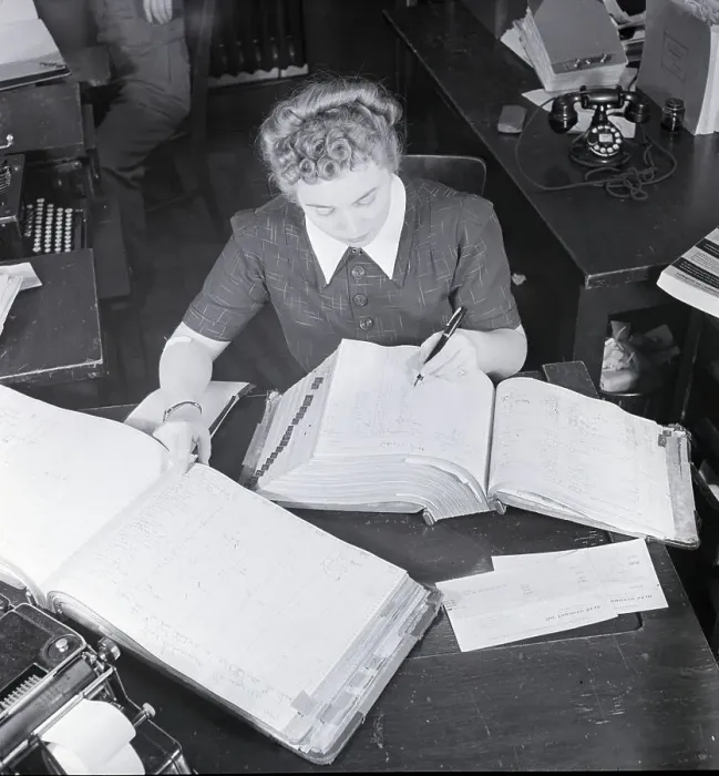 Framed Print : Female Office Worker Writing In Book Framed Print : Female Office Worker Writing In Book