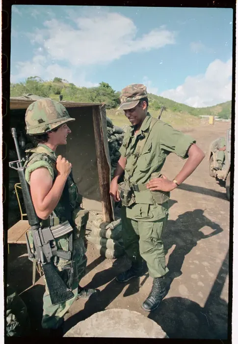 Framed Print : Female Soldier Holding Gun Speaking to Male Soldier Framed Print : Female Soldier Holding Gun Speaking to Male Soldier