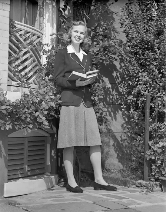 Framed Print : Female student holding book in back yard, portrait Framed Print : Female student holding book in back yard, portrait