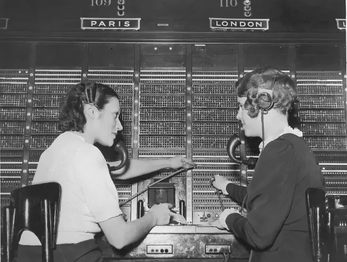 Framed Print : Two female switchboard operators connecting international calls (B&W) Framed Print : Two female switchboard operators connecting international calls (B&W)
