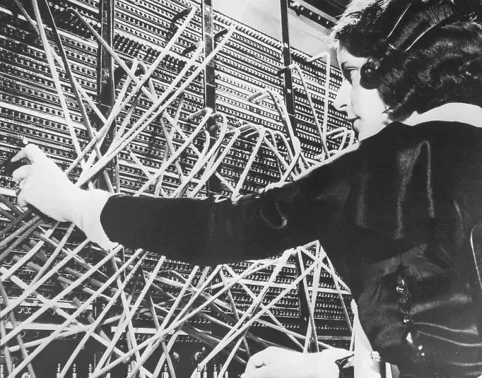 Framed Print : Female telephone switchboard operator connecting caller, close-up (B&W) Framed Print : Female telephone switchboard operator connecting caller, close-up (B&W)