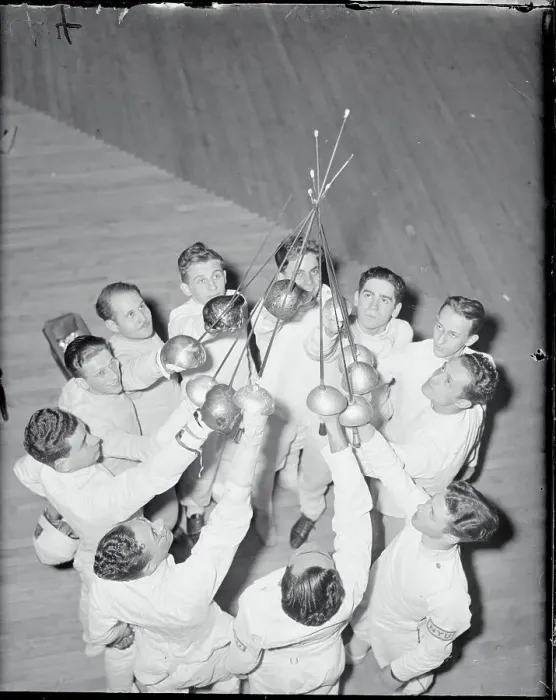 Framed Print : Fencing Teammates Holding Up Their Foils