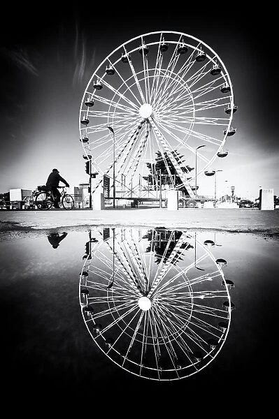 Ferris wheel and its reflection in a puddle, Tours, France