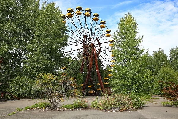 Ferris wheel surrounded by tall trees in Pripyat city near Chernobyl