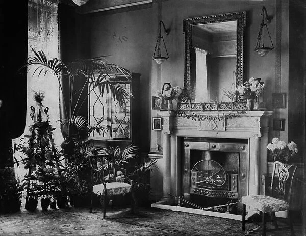 Fireplace. circa 1905: A fireplace in an Edwardian drawing room