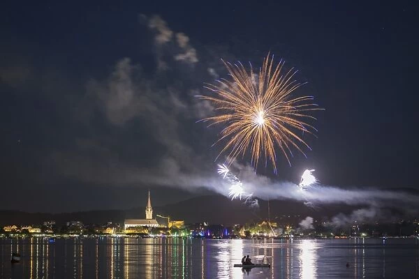 Fireworks during the Hausherrenfest festival, couple on a floating island in Lake Constance at the front, Radolfzell, Baden-Wurttemberg, Germany
