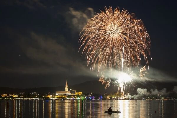 Fireworks during the Hausherrenfest festival, couple on a floating island in Lake Constance at the front, Radolfzell, Baden-Wurttemberg, Germany