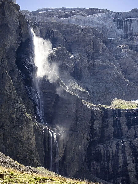 The first plane of Gavarnie waterfall with persons. Hautes Pyrenees. France. World Heritage by UNESCO, the great waterfall