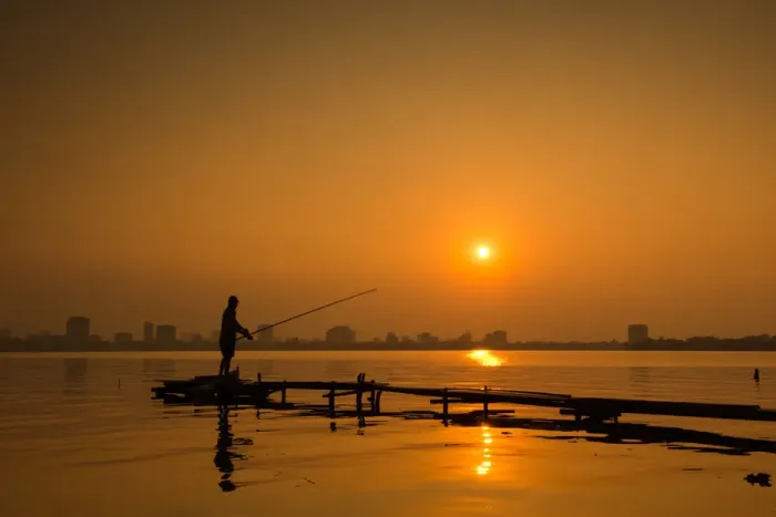 Framed Print : Fisherman fishing on Hanoi West Lake on sunset, Vietnam