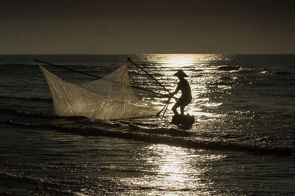 Fisherman with v-shape net in beach