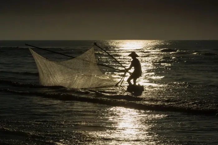 Framed Print : Fisherman with v-shape net in beach Framed Print : Fisherman with v-shape net in beach