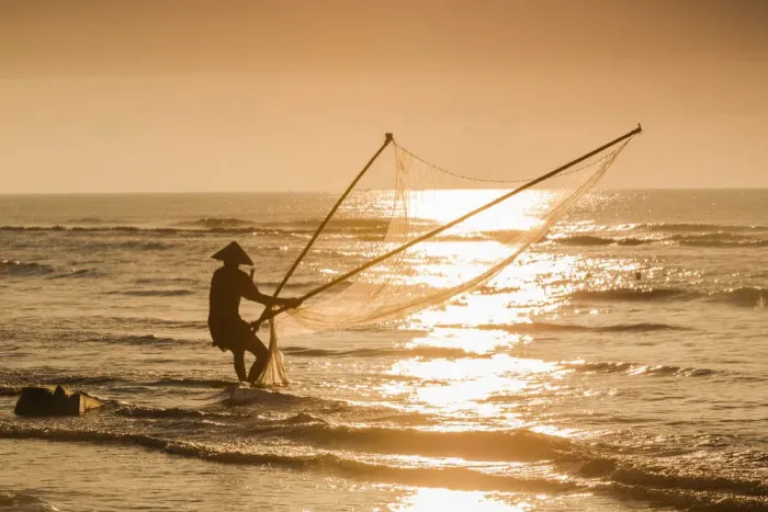 Framed Print : Fisherman with v-shape net in beach Framed Print : Fisherman with v-shape net in beach