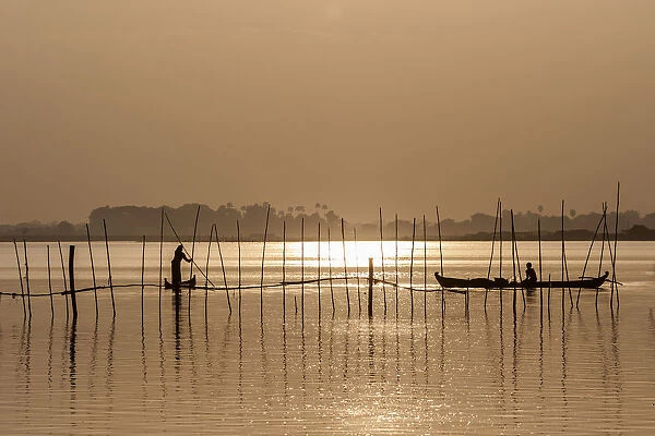 Fishermen in boats in the evening light, Taungthaman Lake, Mandalay, Myanmar