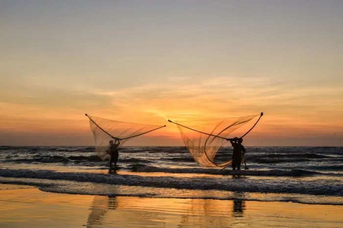 Framed Print : Two Fishermen fishing on the beach at dawn in Vietnam Framed Print : Two Fishermen fishing on the beach at dawn in Vietnam