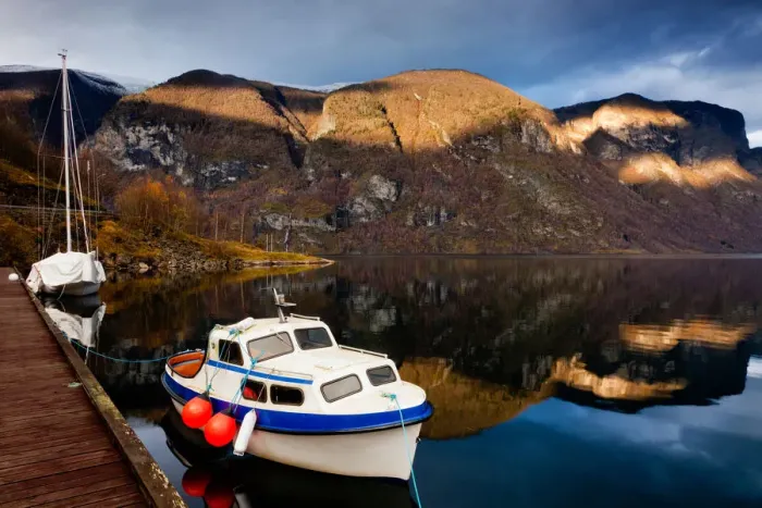 Framed Print : Fjord in spotlight with boats in river
