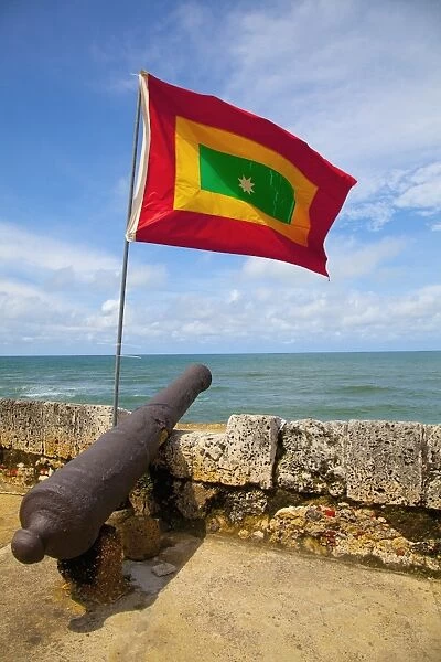 Flag of colombia over cannon on cartagena city wall