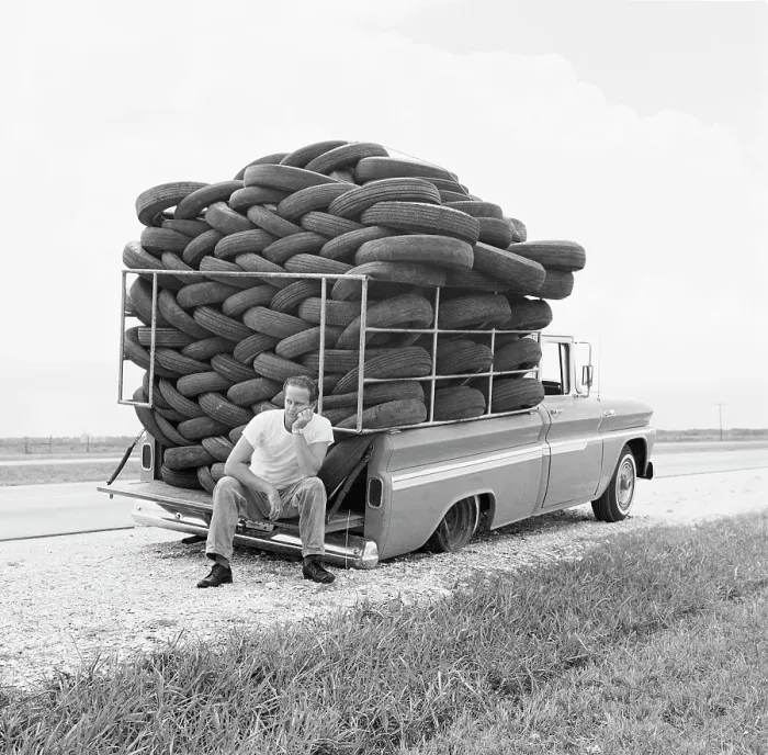 Framed Print : Flat Tire. A man experiences irony as his car Framed Print : Flat Tire. A man experiences irony as his car
