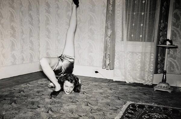 Flexible Woman on the Living Room Floor With Her Leg Over Her Head