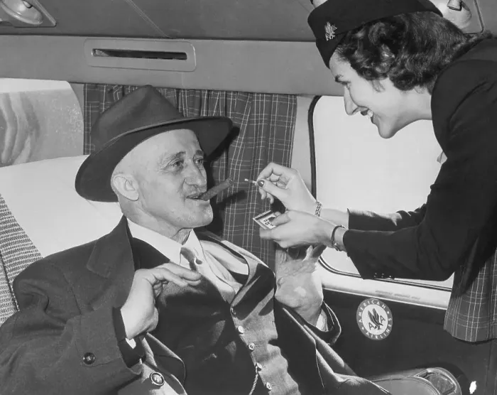 Framed Print : Flight Attendant Lighting Cigar for Passenger Framed Print : Flight Attendant Lighting Cigar for Passenger