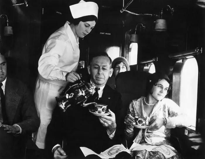 Framed Print : Flight Attendant Pours Passengers Coffee Framed Print : Flight Attendant Pours Passengers Coffee