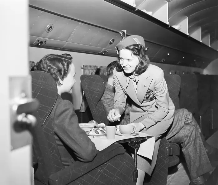 Framed Print : Flight Attendant Serving Passenger a Meal Framed Print : Flight Attendant Serving Passenger a Meal