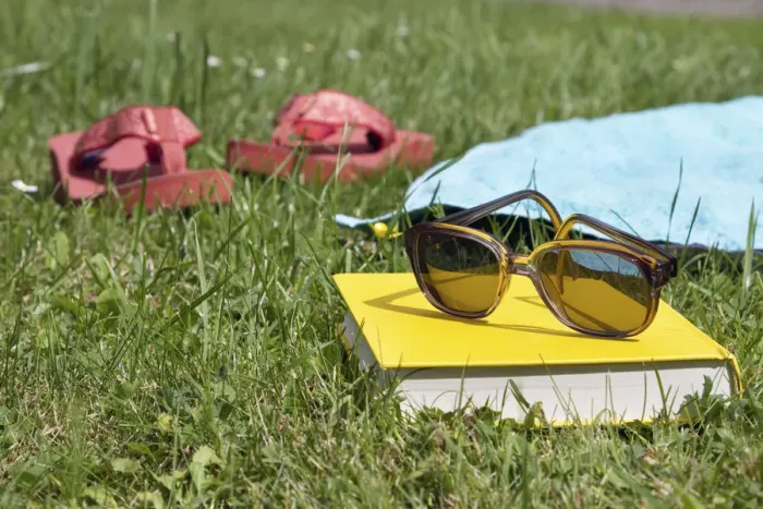 Framed Print : Flip flops, book and sunglasses on grass Framed Print : Flip flops, book and sunglasses on grass