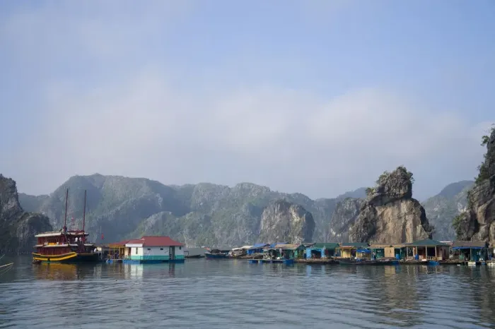 Framed Print : Floating Vietnamese fishing village with rocky coastline