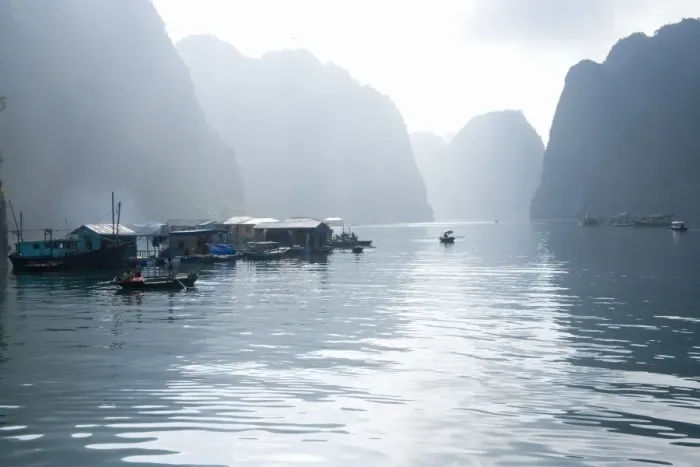 Framed Print : Floating Vietnamese fishing village with rocky coastline Framed Print : Floating Vietnamese fishing village with rocky coastline