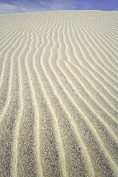 Flowing patterns and shapes created by wind on white gypsum sand dunes