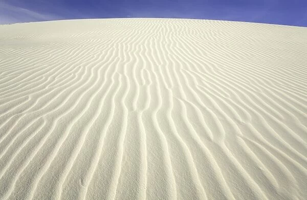 Flowing patterns and shapes created by wind on white gypsum sand dunes