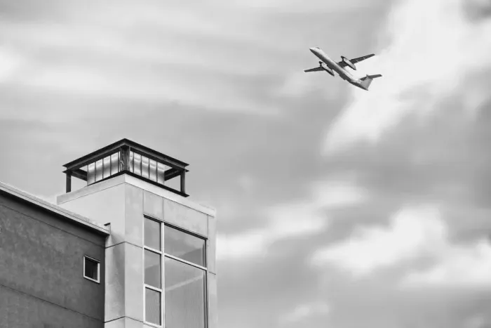Framed Print : Flyover. A black and white photograph of a commercial aircraft flying over Framed Print : Flyover. A black and white photograph of a commercial aircraft flying over