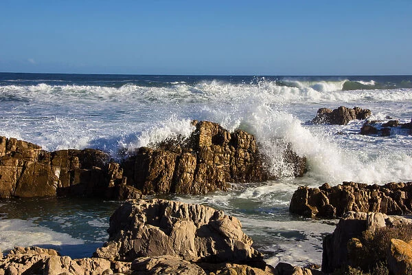 Foamy waves roll over rugged rocks off the point at the popular holiday resort of Buffalo Bay