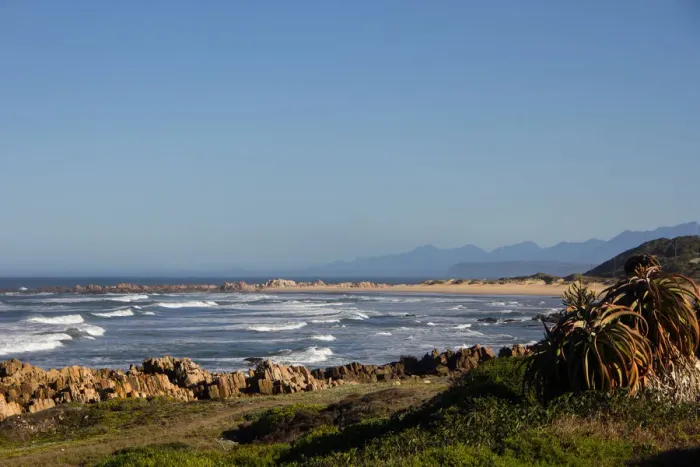 Framed Print : Foamy waves roll over rugged rocks and onto the sandy beach at Buffalo Bay (aka Buffelsbaai)